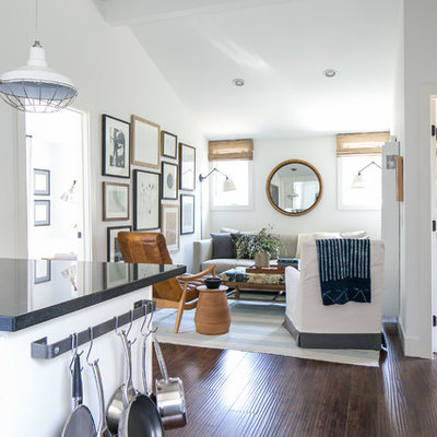 Inspiration for a small country open concept dark wood floor family room remodel in Orange County with white walls and no fireplace