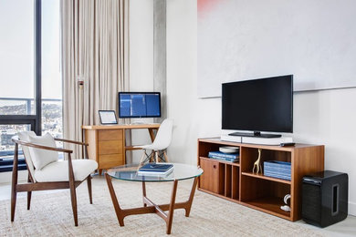 Imagen de sala de estar contemporánea de tamaño medio con paredes blancas, suelo de cemento, televisor independiente y suelo gris