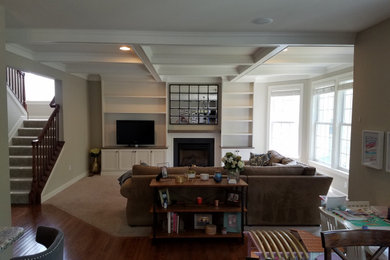 Example of a mid-sized classic open concept carpeted and beige floor family room design in Baltimore with beige walls, a standard fireplace, a wood fireplace surround and a media wall