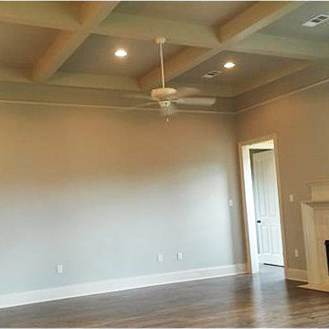 Coffered ceiling design with beams and can lighting in the family room