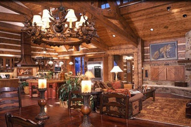 Inspiration for a huge rustic open concept medium tone wood floor family room remodel in Denver with brown walls, a corner fireplace, a stone fireplace and a concealed tv