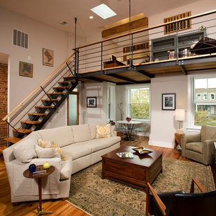 Inspiration for a large industrial medium tone wood floor family room remodel in DC Metro with a tv stand, white walls and no fireplace