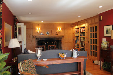 Inspiration for a mid-sized rustic open concept light wood floor and brown floor family room library remodel in Bridgeport with brown walls, a standard fireplace, a brick fireplace and no tv