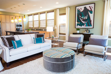 This is an example of a medium sized contemporary open plan games room in DC Metro with green walls, dark hardwood flooring, a standard fireplace, a stone fireplace surround and a wall mounted tv.