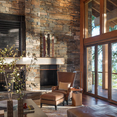 Example of a mountain style family room design in Seattle with a stone fireplace