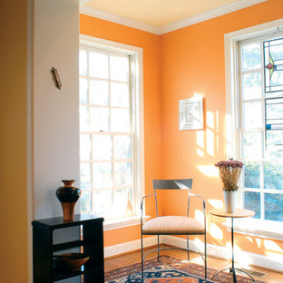 Inspiration for a contemporary medium tone wood floor family room remodel in DC Metro with orange walls