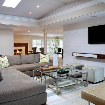 Family room - contemporary open concept dark wood floor family room idea in Orange County with white walls and a wall-mounted tv