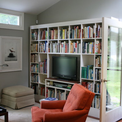 Example of a trendy medium tone wood floor family room library design in Burlington with gray walls and a tv stand