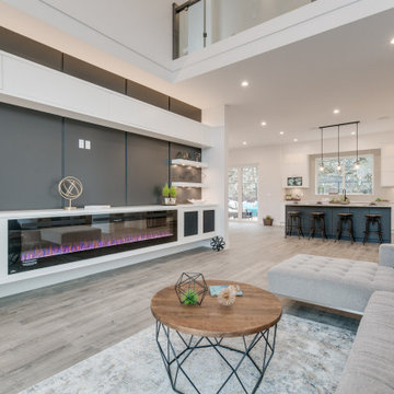 Contemporary Great Room w/ Large Fireplace & High Ceilings