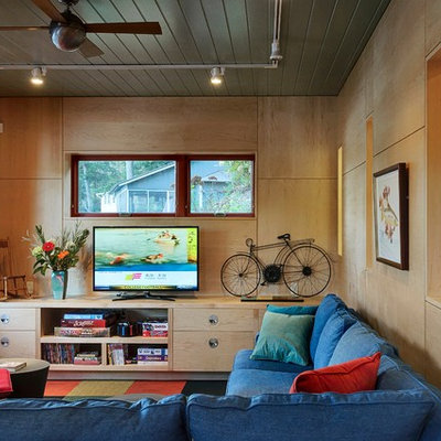 Family room - contemporary enclosed family room idea in Burlington with beige walls and a tv stand
