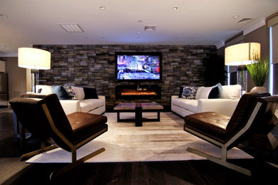 Example of a large trendy enclosed family room design in Baltimore with brown walls, a ribbon fireplace, a stone fireplace and a wall-mounted tv