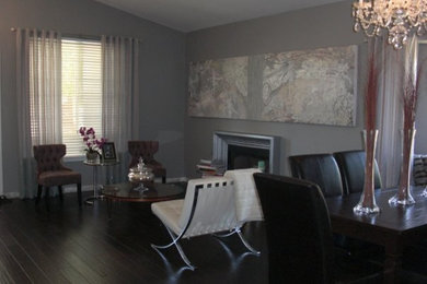 Example of a mid-sized trendy loft-style dark wood floor family room design in San Francisco with gray walls, a standard fireplace and a wood fireplace surround