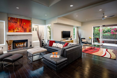 Large transitional open concept dark wood floor family room photo in Phoenix with gray walls, a standard fireplace, a tile fireplace and a wall-mounted tv