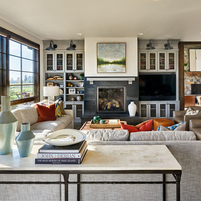 Family room - large country open concept dark wood floor and brown floor family room idea in Portland with white walls, a standard fireplace and a media wall