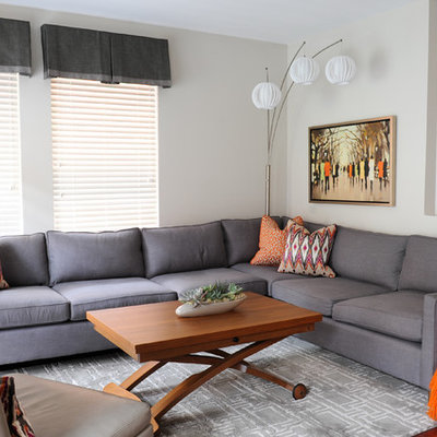 Example of a small trendy open concept medium tone wood floor family room design in Vancouver with gray walls, no fireplace and a wall-mounted tv
