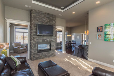 Example of a mid-sized transitional open concept carpeted family room design in Other with gray walls, a two-sided fireplace, a stone fireplace and a wall-mounted tv