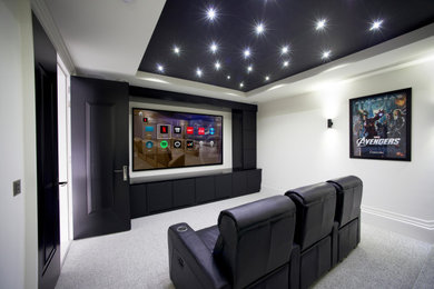 Inspiration for a large home theater remodel in Miami with a media wall
