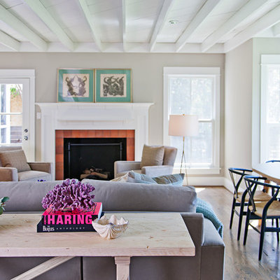 Example of a classic open concept dark wood floor family room design in Dallas with beige walls and a standard fireplace