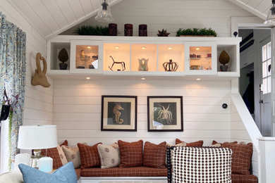 Inspiration for a large farmhouse open concept dark wood floor, brown floor, vaulted ceiling and shiplap wall family room remodel in Providence with white walls and a wall-mounted tv