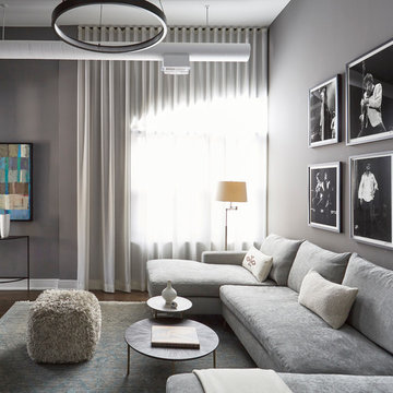 Cozy Family Room with Gray Sectional Sofa and Black and White Art