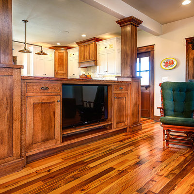 Family room library - small craftsman open concept medium tone wood floor family room library idea in Other with a media wall, white walls and no fireplace
