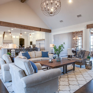Large country open concept dark wood floor and brown floor family room photo in Dallas with gray walls and a wall-mounted tv