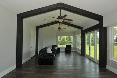 Example of a large arts and crafts gray floor game room design in Houston with gray walls