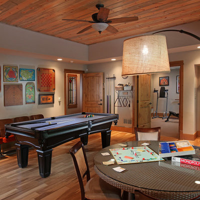 Family room - large traditional enclosed medium tone wood floor family room idea in Atlanta with gray walls and no fireplace