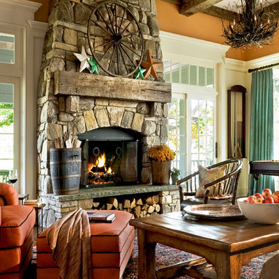 Inspiration for a timeless family room remodel in New York with orange walls and a stone fireplace