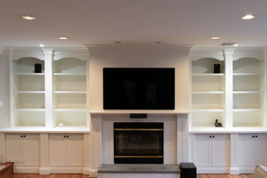 This is an example of a large classic games room in New York with a built-in media unit.