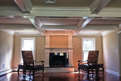 Example of a classic medium tone wood floor family room design in New York with a standard fireplace and a stone fireplace