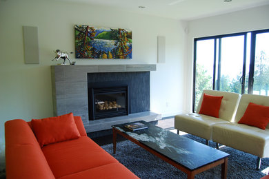 Example of a trendy family room design in Vancouver with a tile fireplace