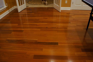 Large open concept medium tone wood floor game room photo in Charlotte