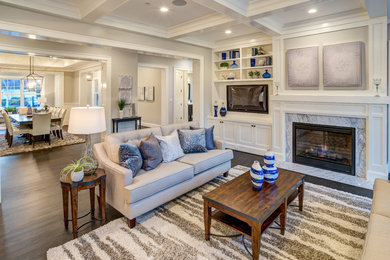 This is an example of a large traditional open plan games room in DC Metro with grey walls, dark hardwood flooring, a standard fireplace, a stone fireplace surround, a built-in media unit and brown floors.