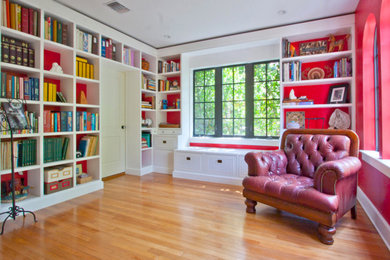 Large trendy open concept light wood floor and orange floor family room library photo in Miami with red walls, no fireplace and no tv