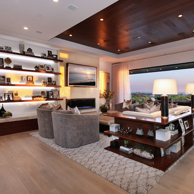 Family room - large contemporary open concept light wood floor and beige floor family room idea in Orange County with white walls, a ribbon fireplace, a wall-mounted tv and a metal fireplace