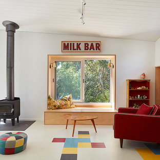 Midcentury family room in Melbourne with white walls, a wood stove, a metal fireplace surround and multi-coloured floor.