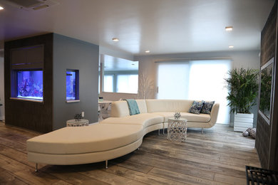 Large trendy open concept light wood floor family room photo in Providence with gray walls, no fireplace and a media wall