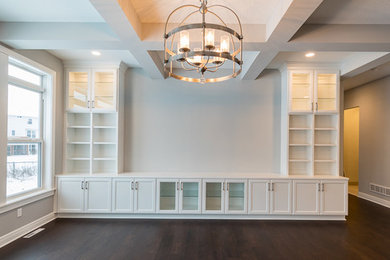 Photo of an expansive classic open plan games room in Minneapolis with grey walls, dark hardwood flooring, a wall mounted tv and brown floors.