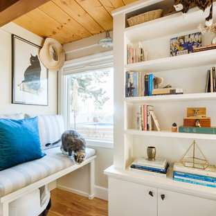 Inspiration for a mid-sized coastal enclosed light wood floor and brown floor family room library remodel in San Diego with beige walls and no fireplace