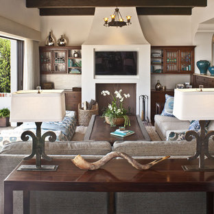Inspiration for a mid-sized mediterranean open concept dark wood floor and brown floor family room remodel in Los Angeles with beige walls, a wall-mounted tv and no fireplace