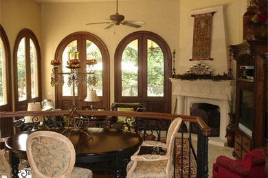 Tuscan family room photo in Dallas