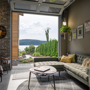 Urban concrete floor and gray floor family room photo in Seattle with gray walls