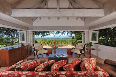 Inspiration for a mid-sized tropical open concept terra-cotta tile and red floor family room remodel in Hawaii with white walls, no fireplace and no tv