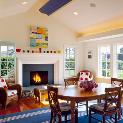 Inspiration for an eclectic medium tone wood floor family room remodel in Boston with beige walls, a standard fireplace and a stone fireplace