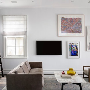 Photo of a contemporary family room in Sydney with white walls, dark hardwood floors, a wall-mounted tv and brown floor.
