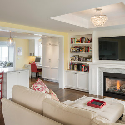 Inspiration for a contemporary open concept dark wood floor family room remodel in Seattle with yellow walls, a standard fireplace and a wall-mounted tv