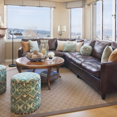 Family room - traditional light wood floor family room idea in San Francisco with beige walls and a corner fireplace