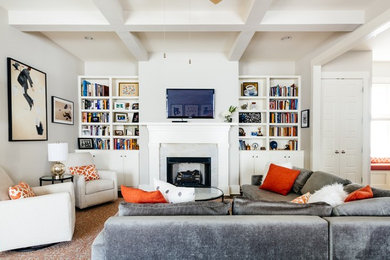 Inspiration for a transitional enclosed multicolored floor family room remodel in Nashville with beige walls, a standard fireplace and a wall-mounted tv