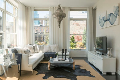 Ejemplo de sala de estar contemporánea con paredes beige, suelo de madera oscura y televisor independiente